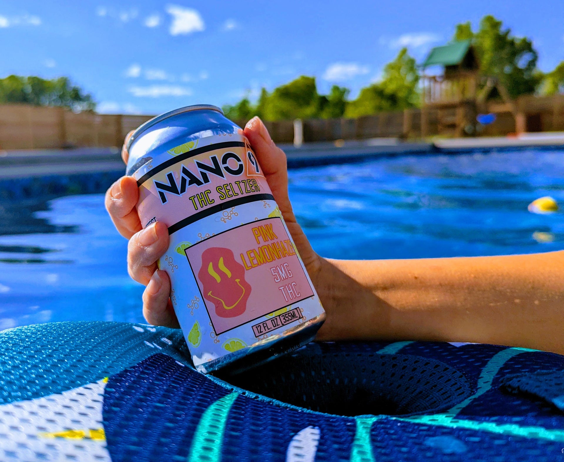 Drinking Nano 9 THC Seltzer while floating in the swimming pool